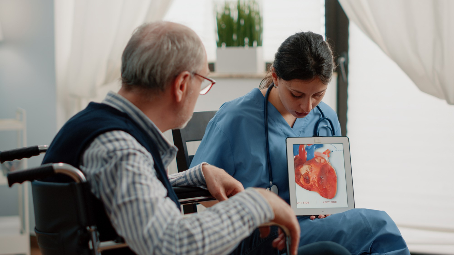 Nurse holding tablet with heart image on it